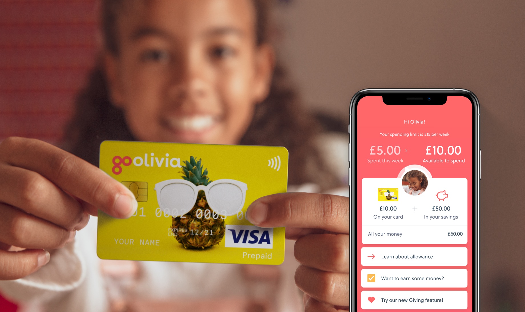 young girl holds out debit card with a pineapple wearing sunglasses for GoHenry card
